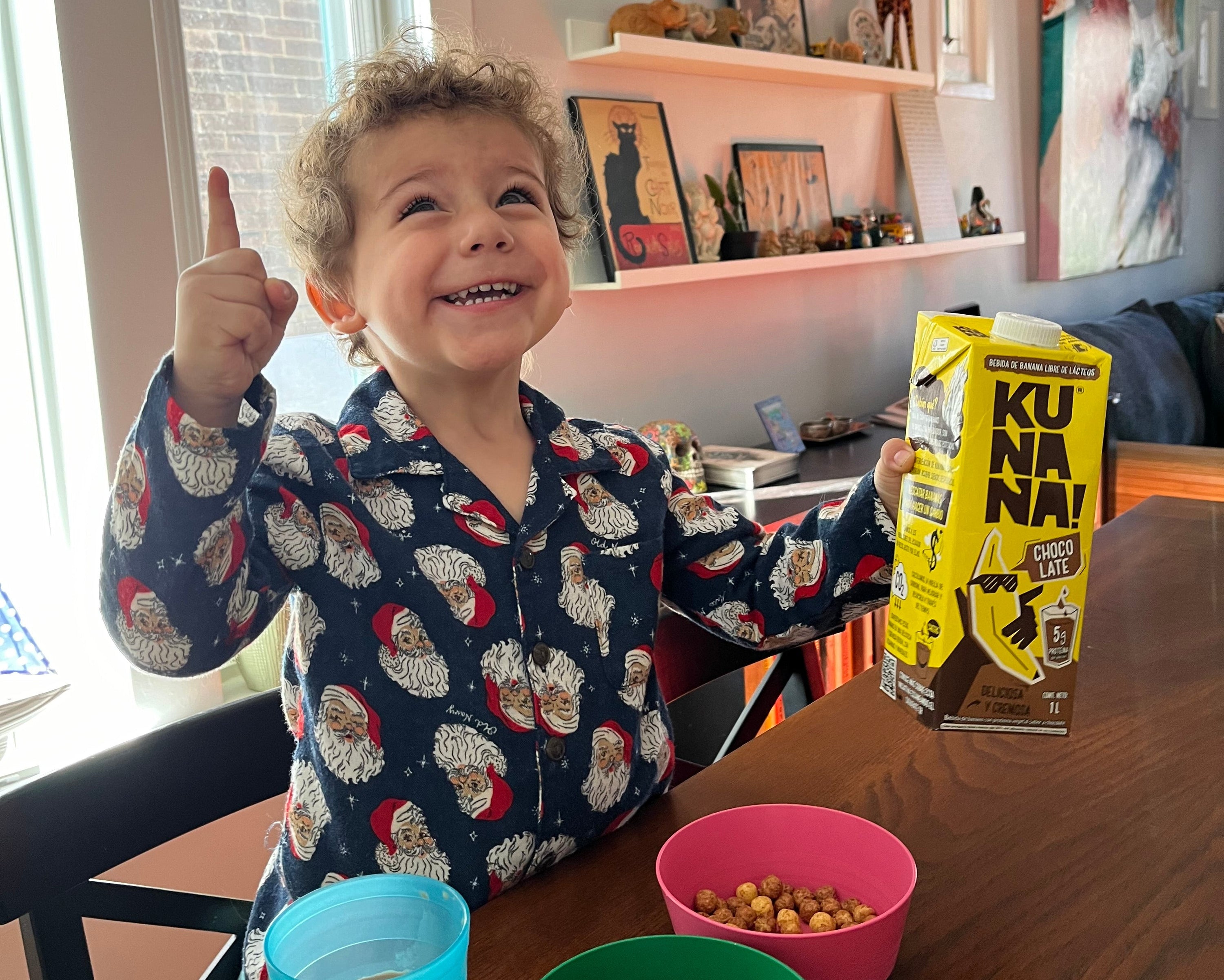 Child in a room with colorful toys and a window in the background